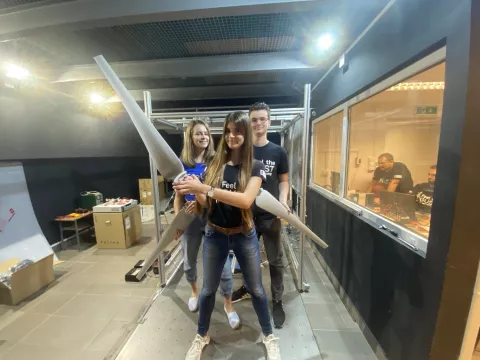 Students with wind turbine wings in hands in the laboratory