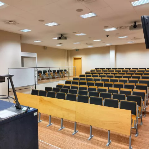 Faculty auditorium in the building of the 21st century Engineers' Factory with chairs and a platform - a lectern