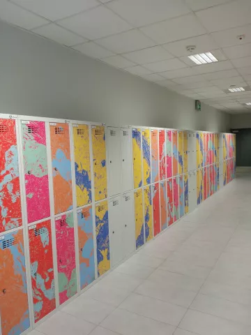 Colorful student clothes lockers arranged in a row in the corridor